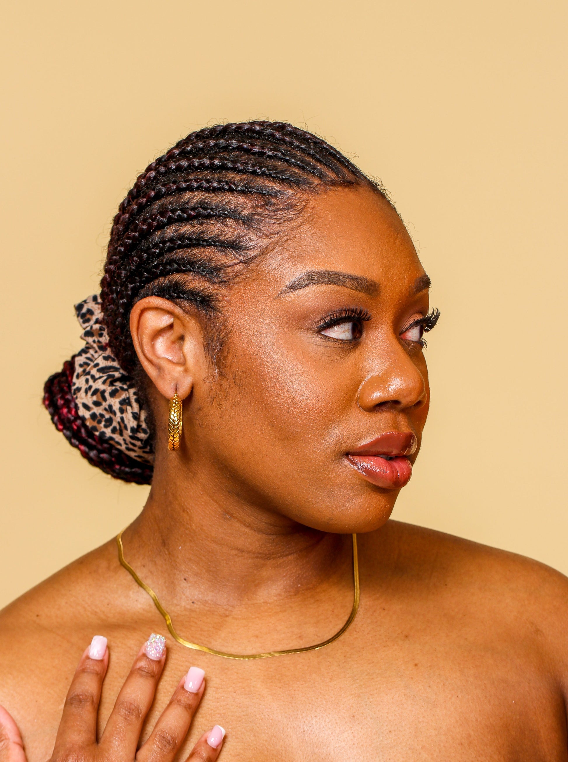 beautiful black woman in gold jewelry braids